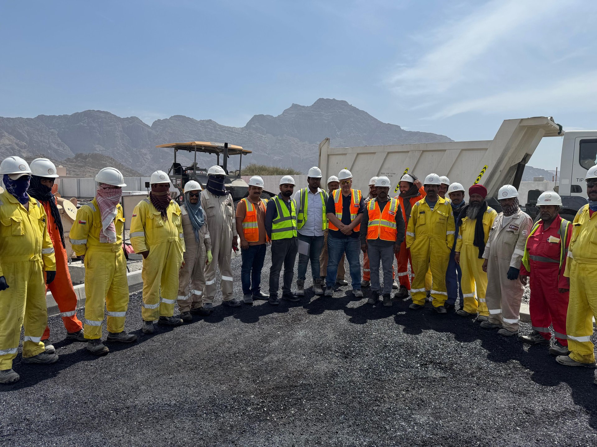 Site crew in PPE on completed asphalt corridor