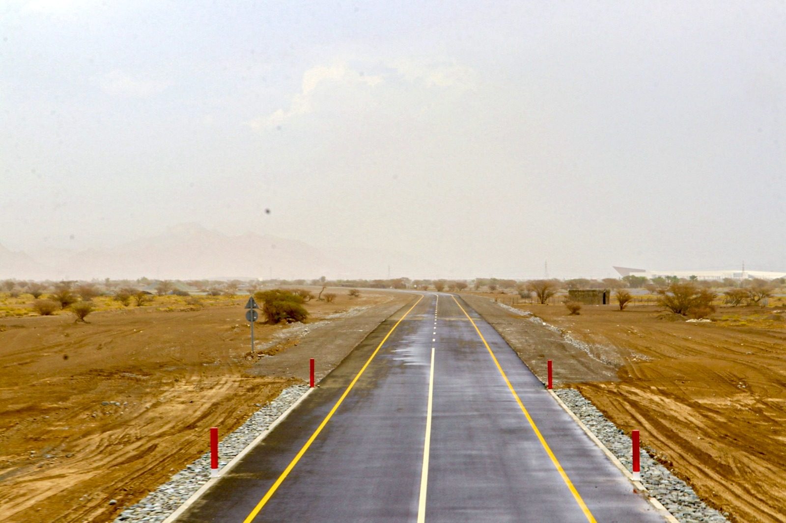 The completed link road running straight towards distant mountains, with new centre line and edge markings