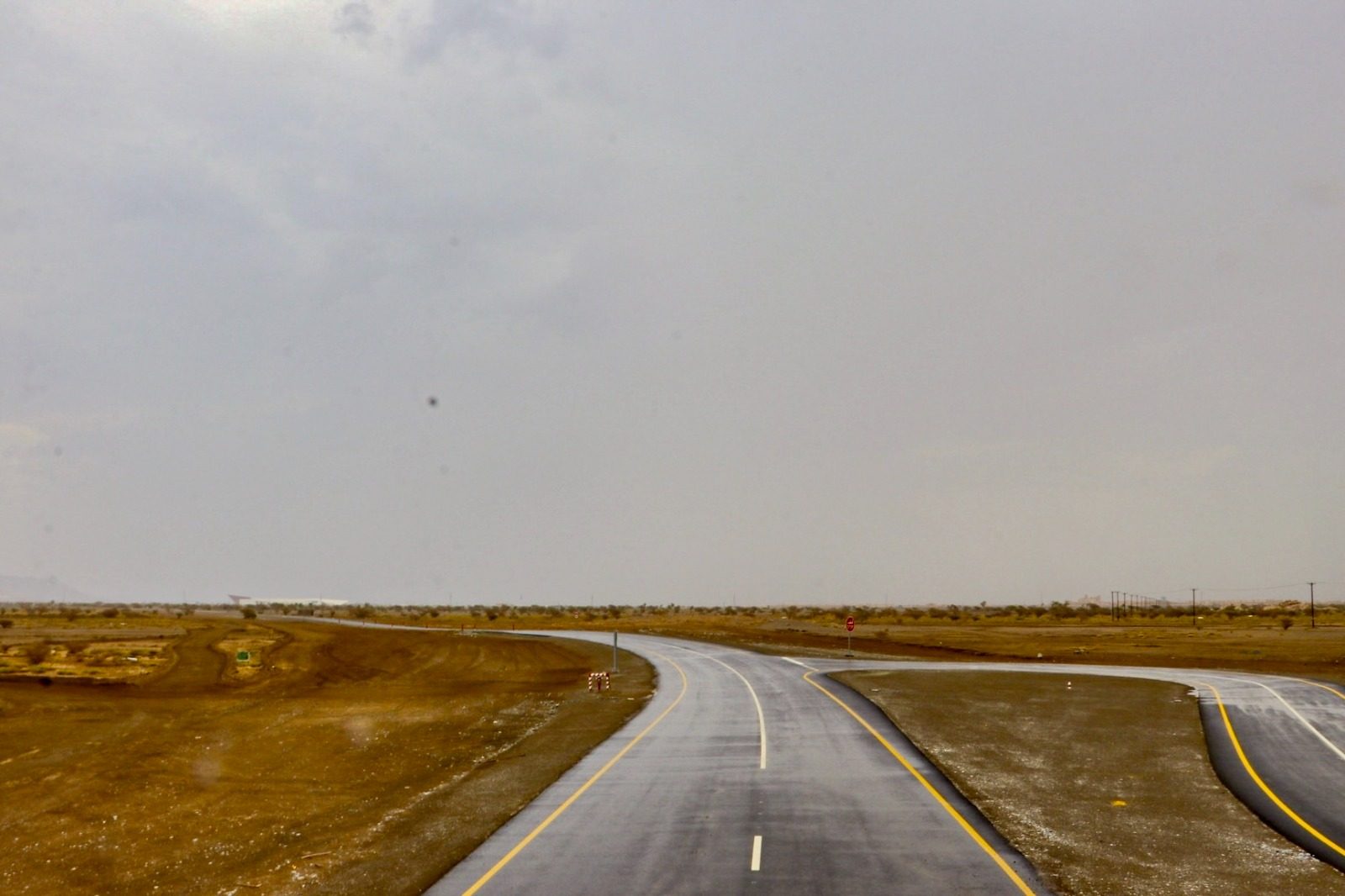 The junction where the link road meets the service road, with traffic signs installed